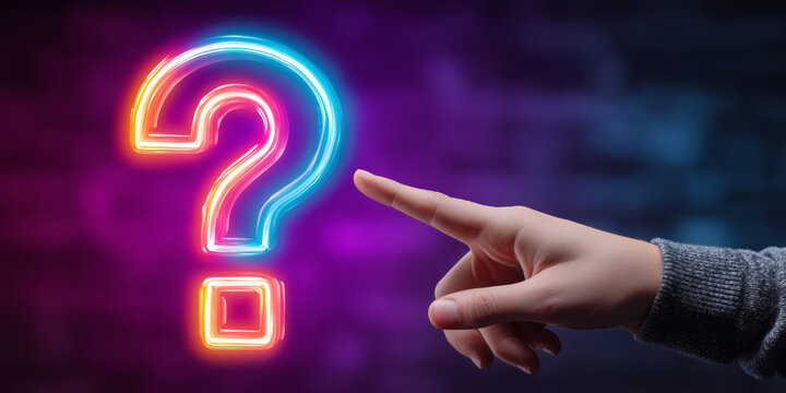 Male hand reaching for a neon question mark in a dark setting