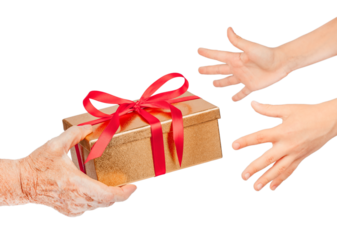 Elderly hand offering a golden gift box with red ribbon to younger hands reaching out, isolated. Symbol of giving, love, care, hope, connection between generations for holiday, family concepts.
