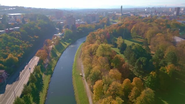 Aerial panshot over River and Komensky cit parkland with autumn colour