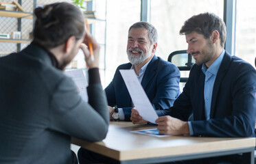 Successful business professionals presenting analytical report, working together in corporate office