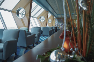 Luxurious modern observation or panorama lounge with floor to ceiling windows onboard expedition cruiseship cruise ship liner with comfortable seating and amazing views