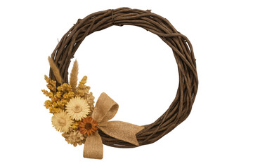 Rustic grapevine wreath decorating for autumn, featuring dried flowers and a natural burlap bow on dark background