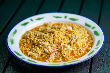 Mie nyemek. An Indonesian noodle dish cooked with a little water, beaten egg, and thick sauce.