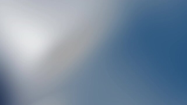 Soft gradient of cool tones with one bright diagonal highlight, blending pale gray into deep blue in a smooth, abstract blur