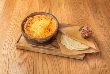 Michoacán-style carnitas tacos with a mix of cuerito, densa, and buche, accompanied by raw salsa verde and chopped onions