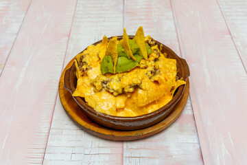nachos with Mexican crema, sprinkled cotija cheese, and crispy fried onions