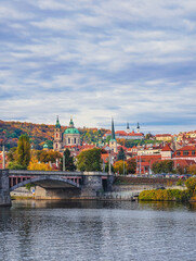 Obraz premium Prague Cityscape Autumn Panorama Vltava River Historic Bridges Church Architecture Fall Foliage Czech Republic European Travel Destination