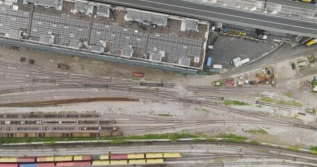 Aerial view of extensive railway tracks and solar panels atop buildings, showcasing a blend of transportation and renewable energy, Trieste, Friuli-Venezia Giulia, Italy. - Powered by Adobe