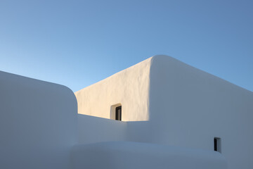 abstract modern white building on clear blue sky background with copy space. modern mediterranean architecture. minimalist greek architectural design. luxury