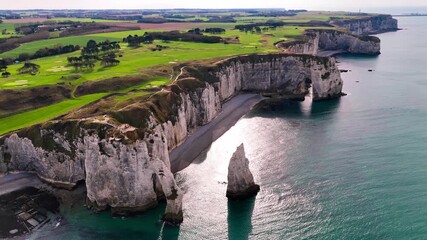 Aerial drone view of picturesque coastal limestone cliffs and the English Channel town of Etretat, France, October 18, 2025. High quality 4k footage