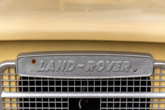 Old Land Rover front grille showcasing classic design and rugged appeal in a vintage setting