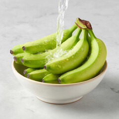 Fresh Green Bananas in Bowl with Water Splash on Light Marble Background