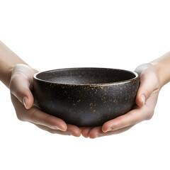 Elegant hands holding dark ceramic bowl with speckles