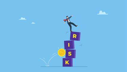 Businessman investor falling from stack block with word RISK impact by money coin. Investment risk, volatility and fluctuation in stock market that price will drop, stability and uncertainty.