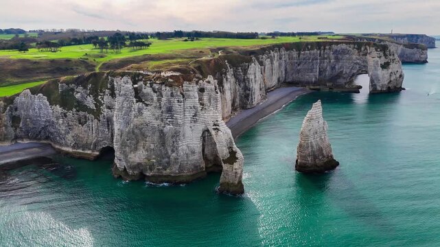 Aerial drone view of picturesque coastal limestone cliffs and the English Channel town of Etretat, France, October 18, 2025. High quality 4k footage