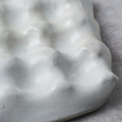 ceramic tray for jewelry on gray background.