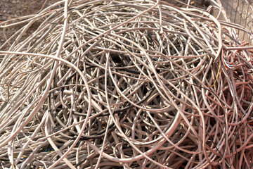Pile of old electrical cables on the ground of a construction site.