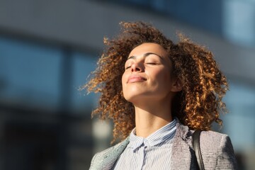 Woman standing outside the office, breathing fresh air to reset and find mindfulness.