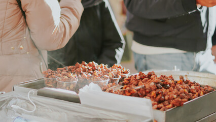 Sweet roasted peanuts at a festive London street market close up.