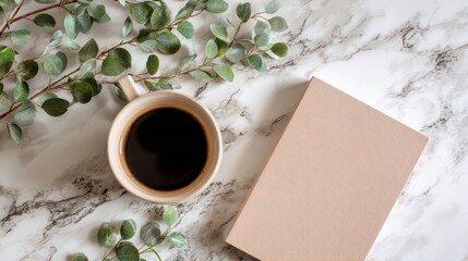 Top view of coffee cup, notebook and eucalyptus branch on marble table