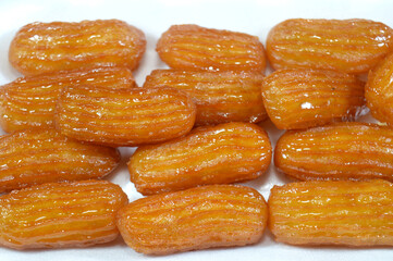 Balah el Sham or Egyptian Choux Pastry, very popular Ramadan month dessert in Egypt and middle east, crispy and tender choux pastry deeply fried and coated in sweet simple sugar syrup, served cold