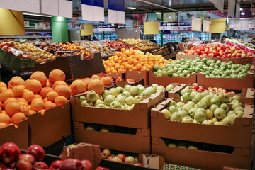 Large variety of fruit is on display in a store.