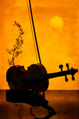 Violin on orange background with reflective surface. Sultry music