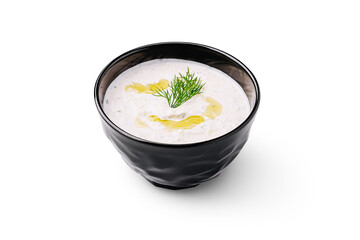 Creamy yogurt dip with fresh herbs served in a dark bowl