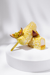 Delicious coconut and passion fruit popsicles on a white pedestal