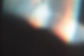 light leak overlay effect with scratch dust and colorful light leaks,retro grain noisy film flare on black background,analog old film burn overlay,abstract background with blur rainbow ray