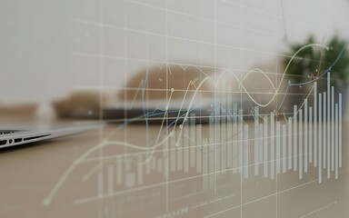 Overlay of financial charts and graphs on a blurred office desk with laptop