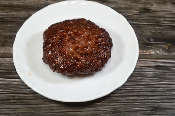Cooked hamburger patty made of ground beef, a ground meat disc, typically seasoned, formed from ground beef meat, grilled in shallow oil, cooked meat burger
