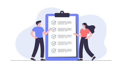 Two people reviewing a completed checklist on a large clipboard with multiple items marked as done and checked off