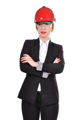 A businesswoman engineer stands in an orange helmet