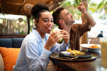 Fast-paced modern lifestyle, enjoying delicious but unhealthy fast food, indulging in quick meals