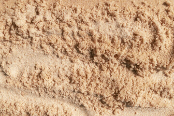 Fine beach sand texture with natural patterns and warm beige tones