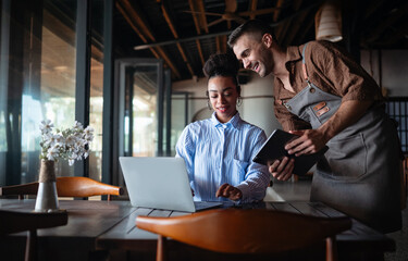 Chef and manager teamwork. Successful meeting with tablet in restaurant for effective collaboration