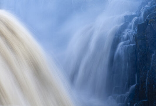 View of the mighty Dettifoss waterfall cascading over dark, jagged cliffs, a misty veil rising from the churning waters, Dettifoss, Nordur&Atilde;&frac34;ing, Iceland.