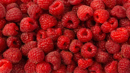 Raspberry in plastic container isolated on white background.