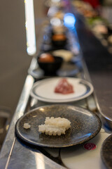 Sliced White Seafood on Plate at Shabu-Shabu Conveyor Belt Restaurant