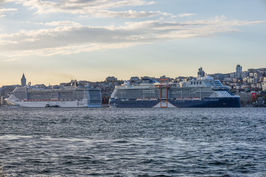 Two massive cruise ships docked in Istanbul, with Galata Tower and city skyline in the background