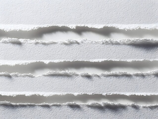 Textured white paper strips with rough torn edges create a dynamic abstract background perfect for design projects and artistic concepts.