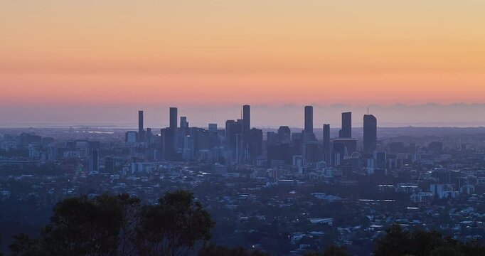 4K locked off stationary sunrise time lapse motion view of the Brisbane Central Business District from the lookout at Mount Cootha at dawn, Brisbane, Queensland, Australia