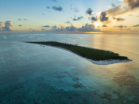 Aerial view of the lush island embraced by turquoise waters under a serene sky, a tranquil haven where the land meets the sea, Progreso, Yucatan, Mexico.