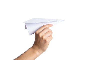 A hand holding a white paper airplane, ready for flight 