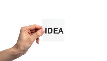 Hand holding a card with the word Idea, symbolizing a creative spark. The hand grasps a white card with bold black text, symbolizing inspiration and insight. The image evokes concept of creativity. 