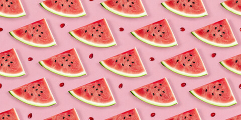 Watermelon slices and seeds create vibrant pattern on pink background, evoking fresh and summery feel
