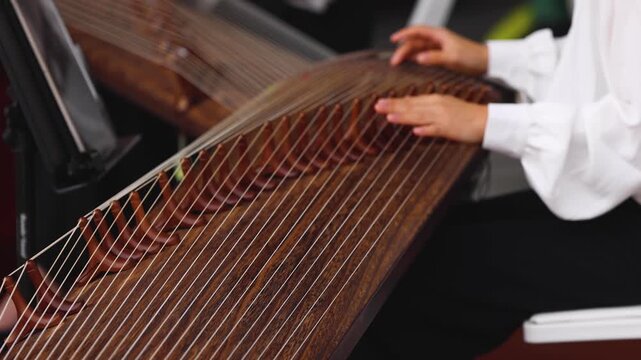 Traditional Korean folk musical instrument Gayageum, female orchestra band performing concert on Kayagum in of Seoul, South Korea, wooden zither with 12 strings, Koto or Guzheng live music performance