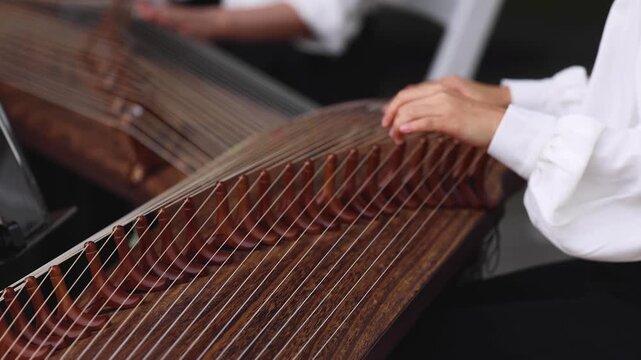 Traditional Korean folk musical instrument Gayageum, female orchestra band performing concert on Kayagum in of Seoul, South Korea, wooden zither with 12 strings, Koto or Guzheng live music performance