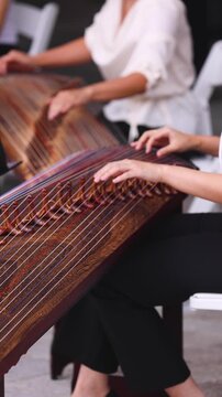 Traditional Korean folk musical instrument Gayageum, female orchestra band performing concert on Kayagum in of Seoul, South Korea, wooden zither with 12 strings, Koto or Guzheng live music performance